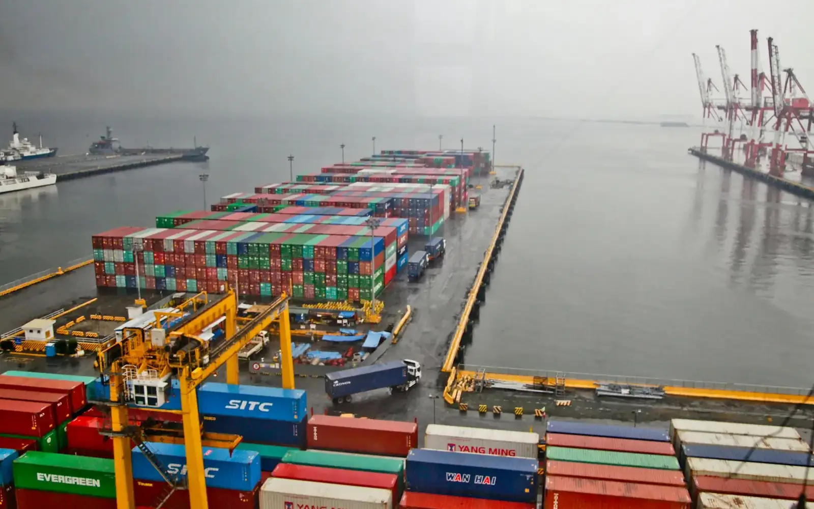 Rows of shipping containers beside the water